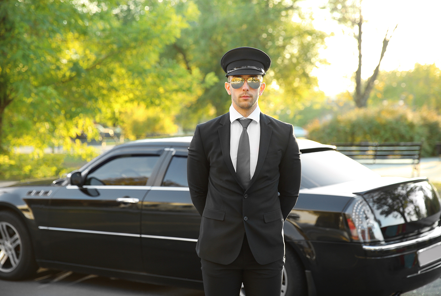 limousine driver standing in front of limo car