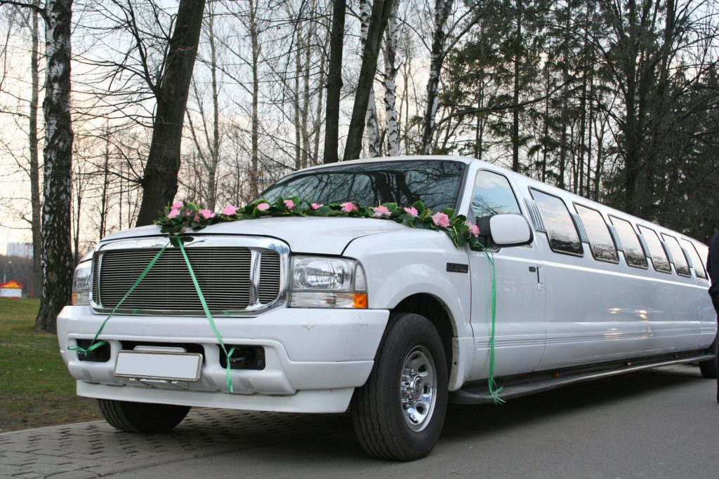 a white limo with flowers on top